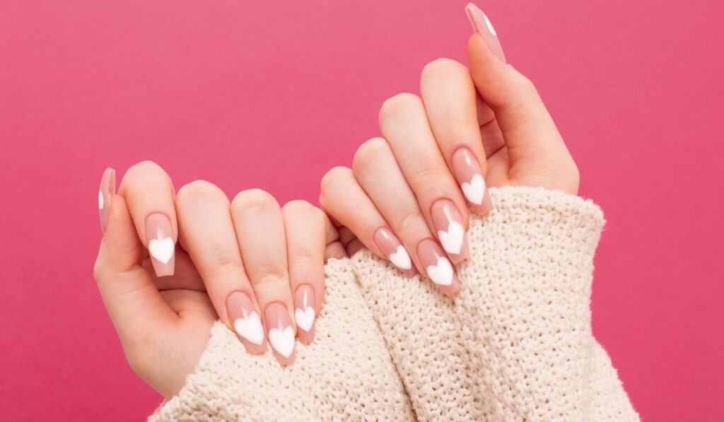 Female,hands,with,beautiful,long,nails,with,manicure,with,heart